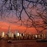 The sun sets on lower Manhattan and One World Trade Center in New York City, Nov. 12, 2019. (Photo by Gary Hershorn/Getty Images)