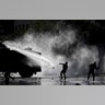 Demonstrators clash with a police water cannon during an anti-government protest in Santiago, Nov. 5, 2019.