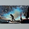 Riot police fire tear gas to disperse anti-government protesters gathering on the al- Shuhada Bridge in Baghdad, Iraq, Nov. 7, 2019.