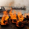Hindus make fires on the banks of the River Ganges as part of rituals during Karthik Purnima festival in Varanasi, India, Nov. 12, 2019. 