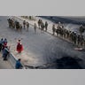 Supporters of former President Evo Morales stand next to soldiers guarding the road leading to the state-own Senkata fuel plant, in El Alto, on the outskirts of La Paz, Bolivia, Nov. 19, 2019.