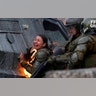 A riot police officer on fire reacts during a protest against Chile's government in Santiago, Chile Nov. 4, 2019