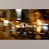 A cyclist rides between cars during an autumn day in Madrid, Spain, Nov. 7, 2019.