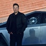 Tesla co-founder and CEO Elon Musk stands in front of the shattered windows of the newly unveiled all-electric battery-powered Tesla's Cybertruck at Tesla Design Center in Hawthorne, California, Nov. 21, 2019. 