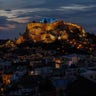 The ancient Parthenon temple atop the Acropolis is lit in blue for UNICEF's World Children's Day celebrations in Athens, Nov. 19, 2019. 