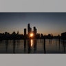 The sun rises behind Hudson Yards and the Empire State Building in New York City, Nov. 3, 2019.