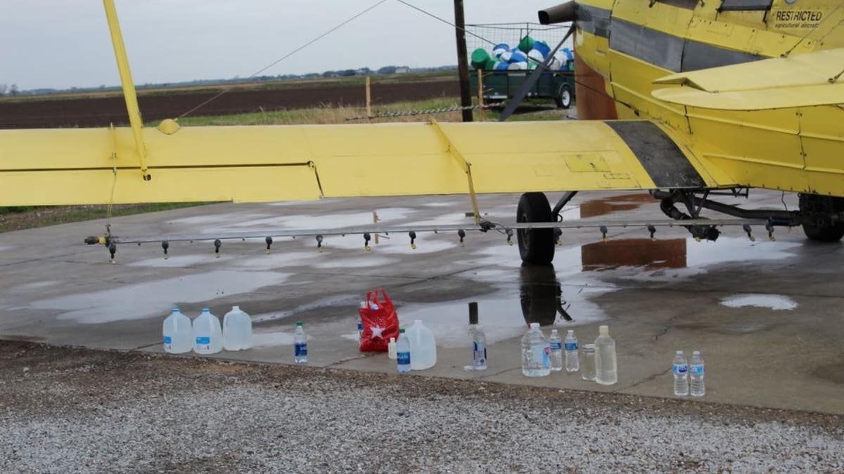 Members of St. Anne Church in Cow Island in Louisiana gathered over the weekend to bless 100 gallons of water to be sprayed onto a town and nearby farms via crop duster.