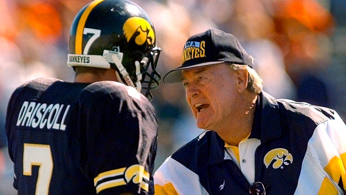 FILE - In this Saturday, Sept. 14, 1996, file photo, Iowa coach Hayden Fry encourages quarterback Ryan Driscoll (7) during the second quarter of an NCAA college football game against Iowa State, in Iowa City, Iowa. Fry, the Texan who revived Iowa football and became a Hawkeye State institution, died Tuesday, Dec. 17, 2019, after a long battle with cancer. He was 90. (AP Photo/Rodney White, File)