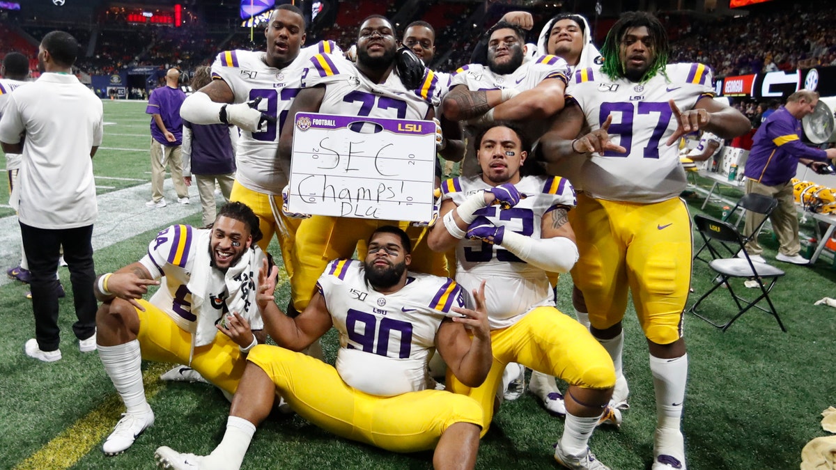 LSU players celebrate after the Southeastern Conference championship NCAA college football game against Georgia, Saturday, Dec. 7, 2019, in Atlanta. LSU won 37-10. (AP Photo/John Bazemore)