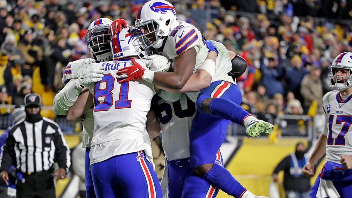Buffalo Bills tight end Tyler Kroft (81) celebrates with running back Devin Singletary (26) and others after scoring on a pass from quarterback Josh Allen during the second half of an NFL football game against the Pittsburgh Steelers in Pittsburgh, Sunday, Dec. 15, 2019. (AP Photo/Don Wright)