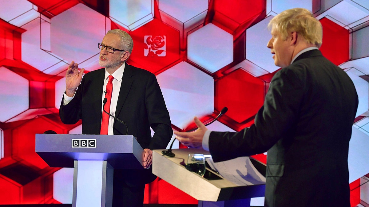 Opposition Labour Party leader Jeremy Corbyn, left, and Britain's Prime Minister Boris Johnson, during a head to head live Election Debate at the BBC TV studios in Maidstone, England, Friday Dec. 6, 2019. (Associated Press)