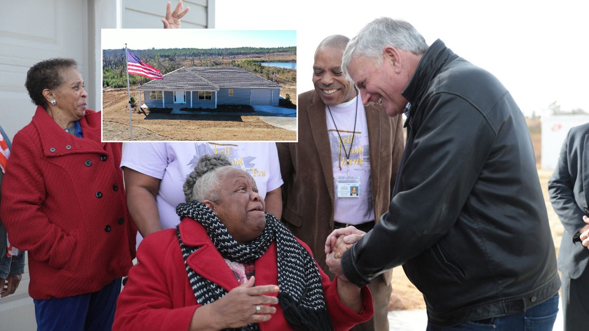 Franklin Graham, the president of Samaritan's Purse, shakes hands with Earnestine Reese, after revealing her new home that was destroyed by tornadoes in March.