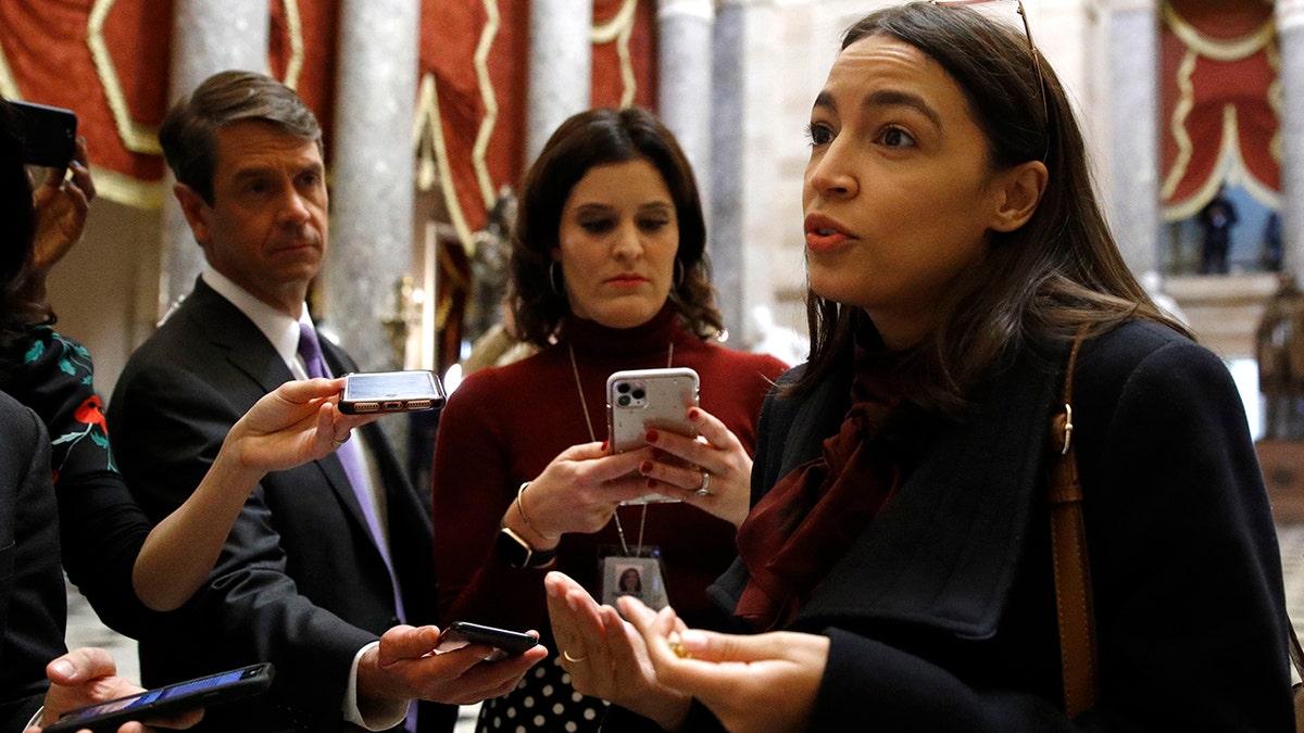 Rep. Alexandria Ocasio-Cortez, D-N.Y., speaks with reporters, Wednesday, Dec. 18, 2019, on Capitol Hill in Washington. President Donald Trump is on the cusp of being impeached by the House, with a historic debate set Wednesday on charges that he abused his power and obstructed Congress ahead of votes that will leave a defining mark on his tenure at the White House. (AP Photo/Patrick Semansky)