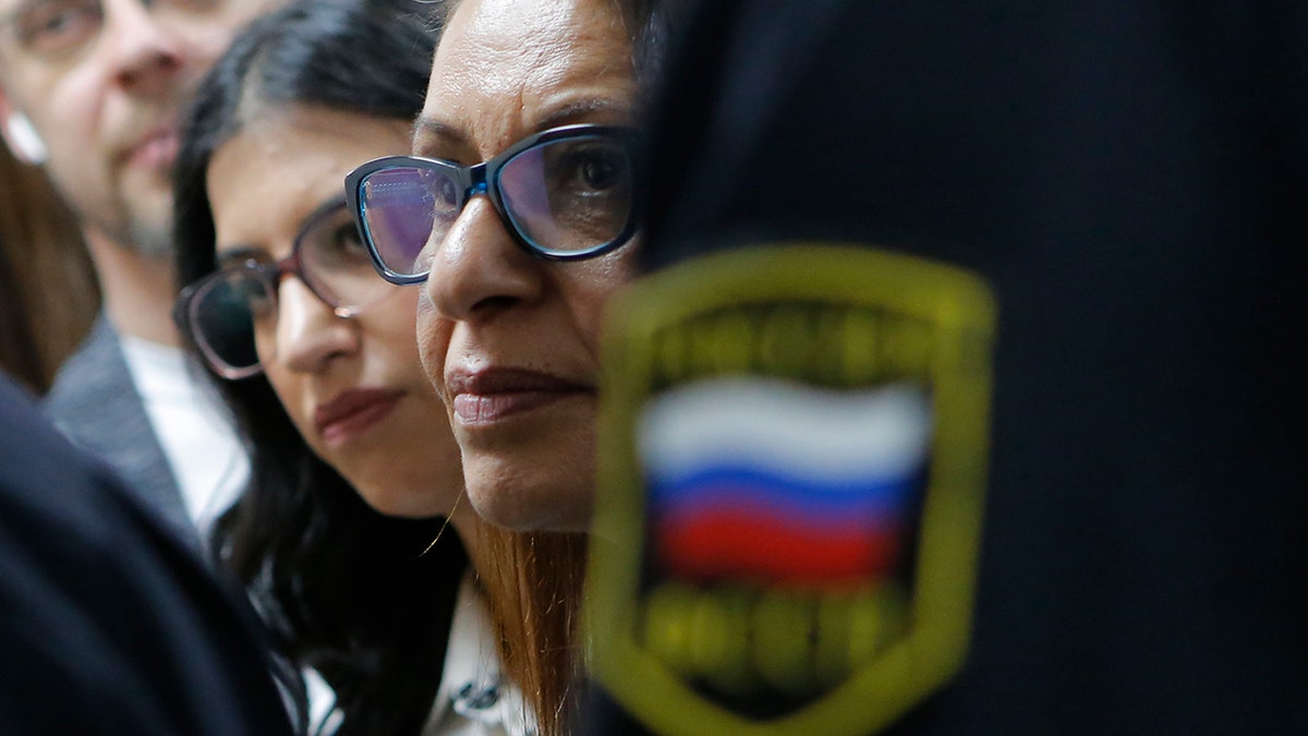 Israeli backpacker Naama Issachar's mother Yaffa Issachar, centre, and sister Liad Goldberg, left, wait to Issachar's appeal hearings in a courtroom in Moscow, Russia, Thursday, Dec. 19, 2019. 