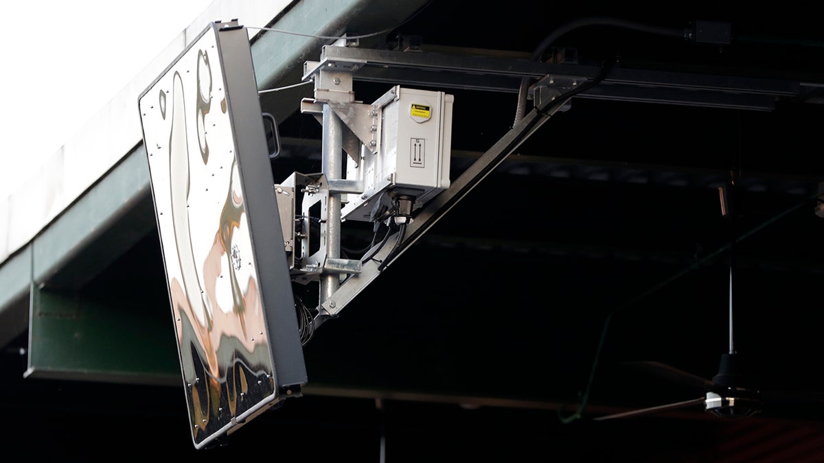 FILE - In this July 10, 2019, file photo, a radar device hangs from the roof behind home plate at PeoplesBank Park during the third inning of the Atlantic League All-Star minor league baseball game in York, Pa.  (AP Photo/Julio Cortez, File)