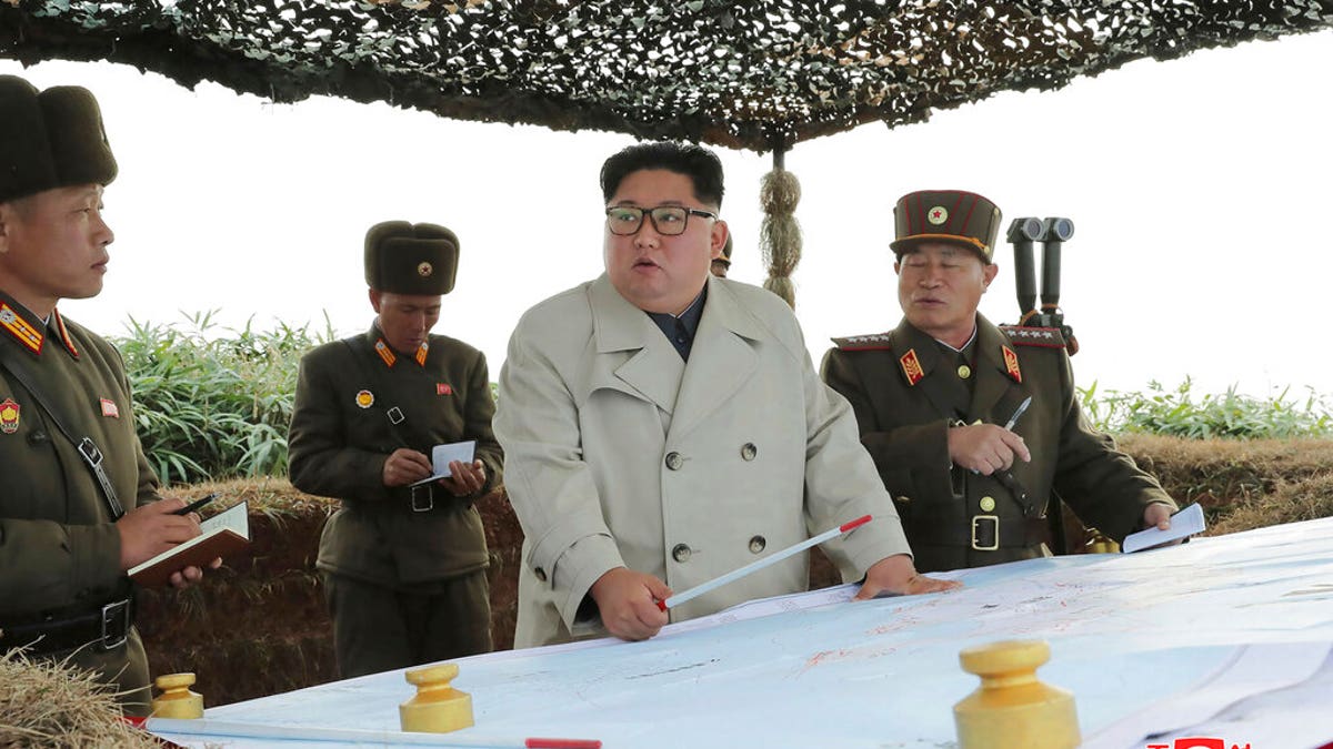 North Korean leader Kim Jong Un, center, inspects a military unit on Changrin Islet in North Korea. 