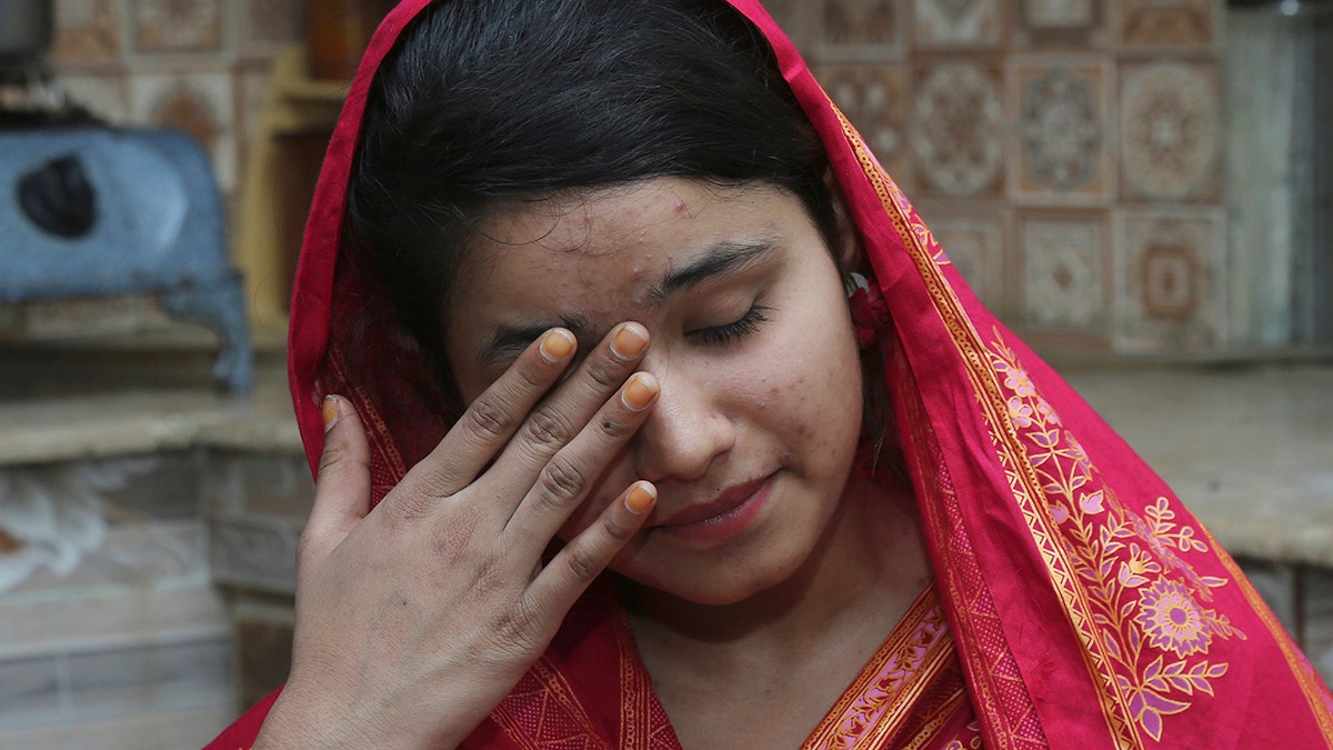 FILE - In this April 14, 2019 file photo, Pakistani Christian Mahek Liaqat, who married a Chinese national, cries as she narrates her ordeal, in Gujranwala, Pakistan. (AP Photo/K.M. Chaudary, File)