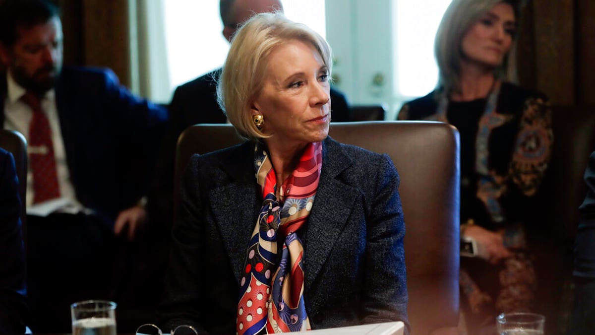 Education Secretary Betsy DeVos listened to President Trump during an October cabinet meeting at the White House. (AP Photo/Pablo Martinez Monsivais, File)