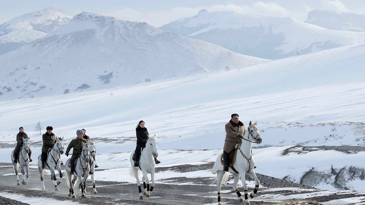 Kim Jong Un, right, and his wife Ri Sol Ju, second from right, riding on white horse during a visit to Mount Paektu, North Korea. (Korean Central News Agency/Korea News Service via AP)