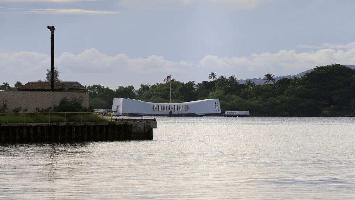 The USS Arizona Memorial can be seen from the Pearl Harbor National Memorial Wednesday, Dec. 4, 2019, in Honolulu. A U.S. sailor shot and wounded several civilian Department of Defense employees before taking their own life on Wednesday, the military said. The shipyard is across the harbor from the Pearl Harbor National Memorial. (AP Photo/Marco Garcia)