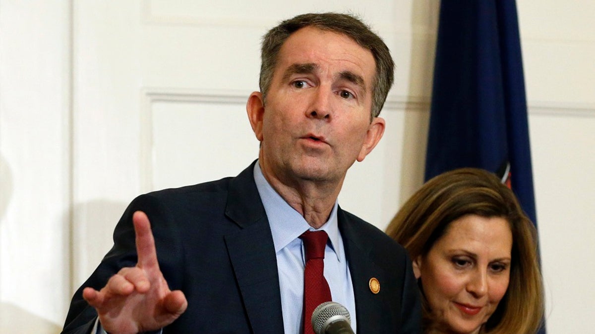 In this Feb. 2, 2019 file photo Virginia Gov. Ralph Northam, left, gestures as his wife, Pam, listens during a press conference in the Governors Mansion at the Capitol in Richmond. A commission Northam tasked with researching racist laws from the state’s past recommended Thursday that dozens be repealed in order to purge the state’s books of discriminatory language. (AP Photo/Steve Helber, File)