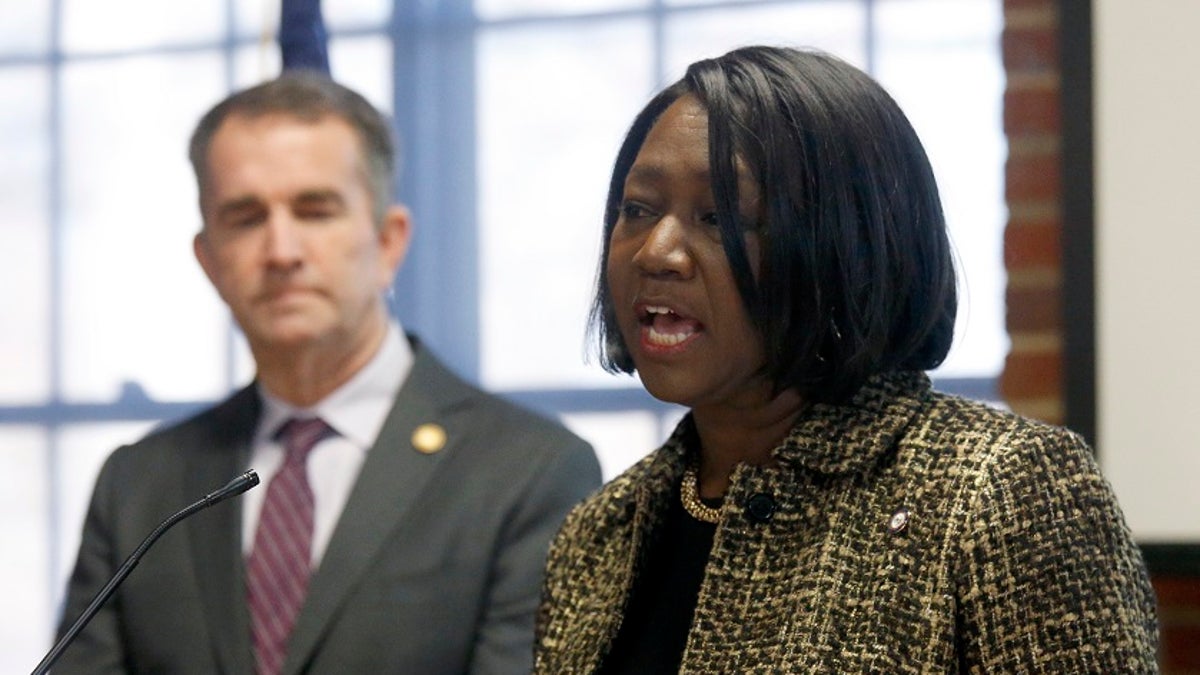 As Gov. Ralph Northam, left, looks on, Chief Deputy Attorney General Cynthia Hudson, left, addresses a gathering as she presented the report from The Commission to Examine Racial Inequity in Virginia Law in Richmond, Va., on Thursday. (Bob Brown/Richmond Times-Dispatch via AP)