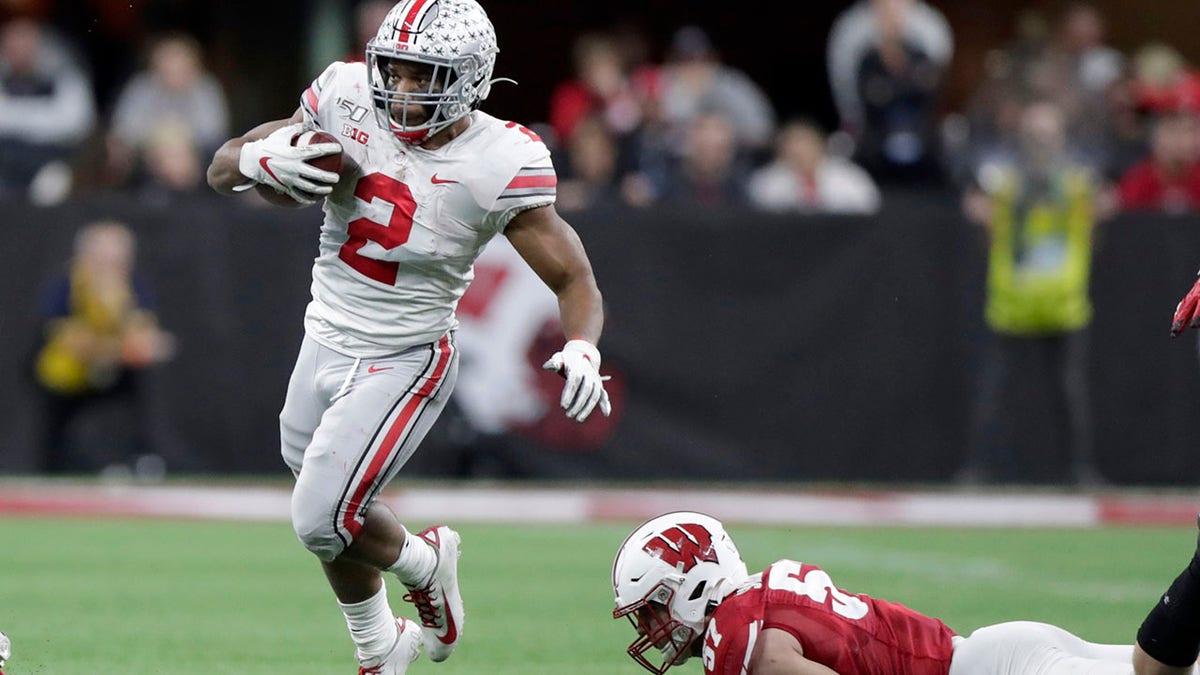 Ohio State running back J.K. Dobbins (2) runs past Wisconsin linebacker Jack Sanborn during the second half of the Big Ten championship NCAA college football game Saturday, Dec. 7, 2019, in Indianapolis. (AP Photo/Michael Conroy)