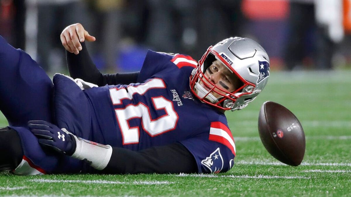 New England Patriots quarterback Tom Brady lands on the turf after being sacked by Kansas City Chiefs defensive end Chris Jones in the second half of an NFL football game, Sunday, Dec. 8, 2019, in Foxborough, Mass.
