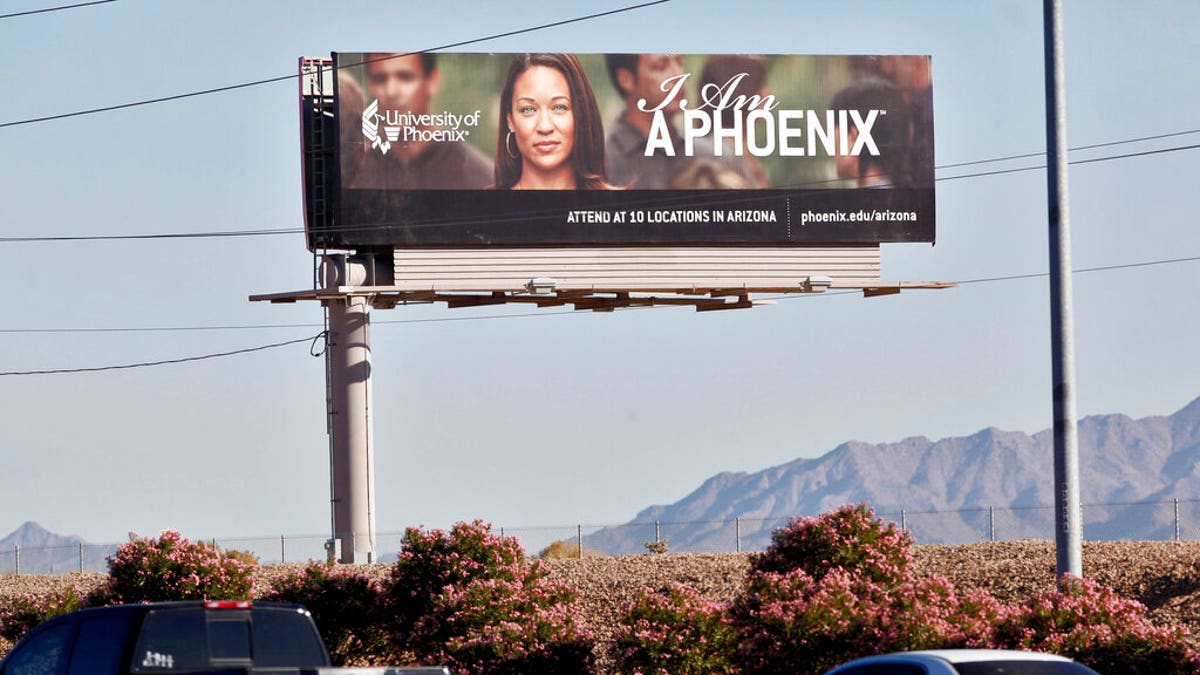 FILE: A University of Phoenix billboard is shown in Chandler, Ariz. 