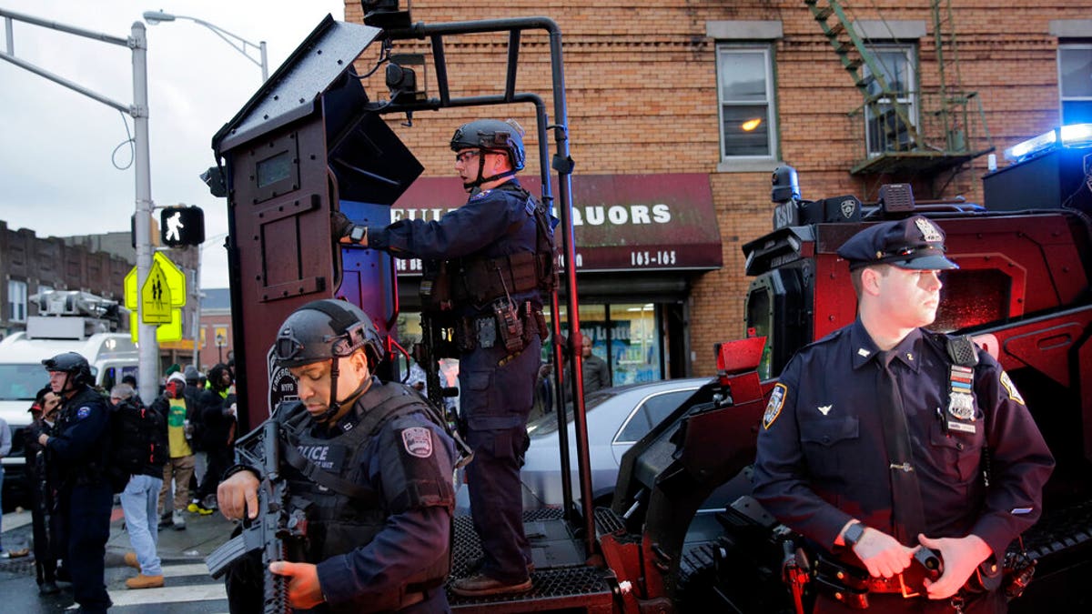 Emergency responders move heavy equipment near the scene of a shooting in Jersey City, N.J., Tuesday, Dec. 10, 2019. 