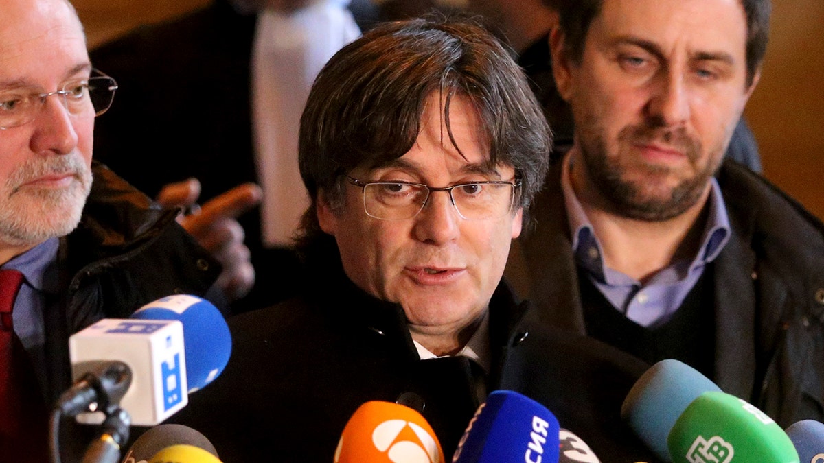 Catalonia's former regional president Carles Puigdemont speaks with journalists as he leaves the Justice Palace in Brussels, Monday, Dec.16, 2019. (AP Photo/Francois Walschaerts)