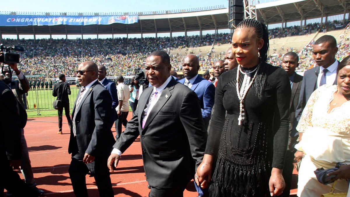 Zimbabwean Vice President Constantino Chiwenga with his wife, Marry, in 2018. (AP Photo/Wonder Mashura, File)