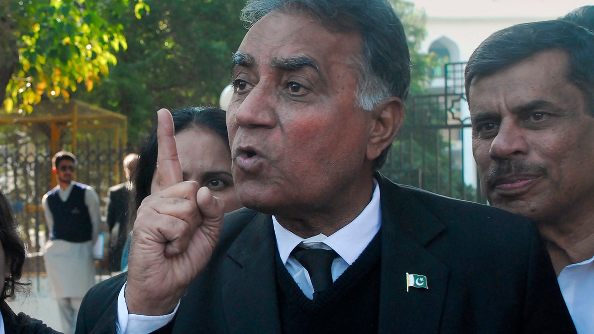 Akhtar Sheikh, a lawyer for former Pakistani military ruler Gen. Pervez Musharraf, talks to media outside a court following a court decision, in Islamabad, Pakistan, Dec. 17, 2019. The Pakistani court sentenced Musharraf to death in a treason case related to the state of emergency he imposed in 2007 while in power, officials said. Musharraf who is apparently sick and receiving treatment in Dubai where he lives was not present in the courtroom. (AP Photo/Anjum Naveed)
