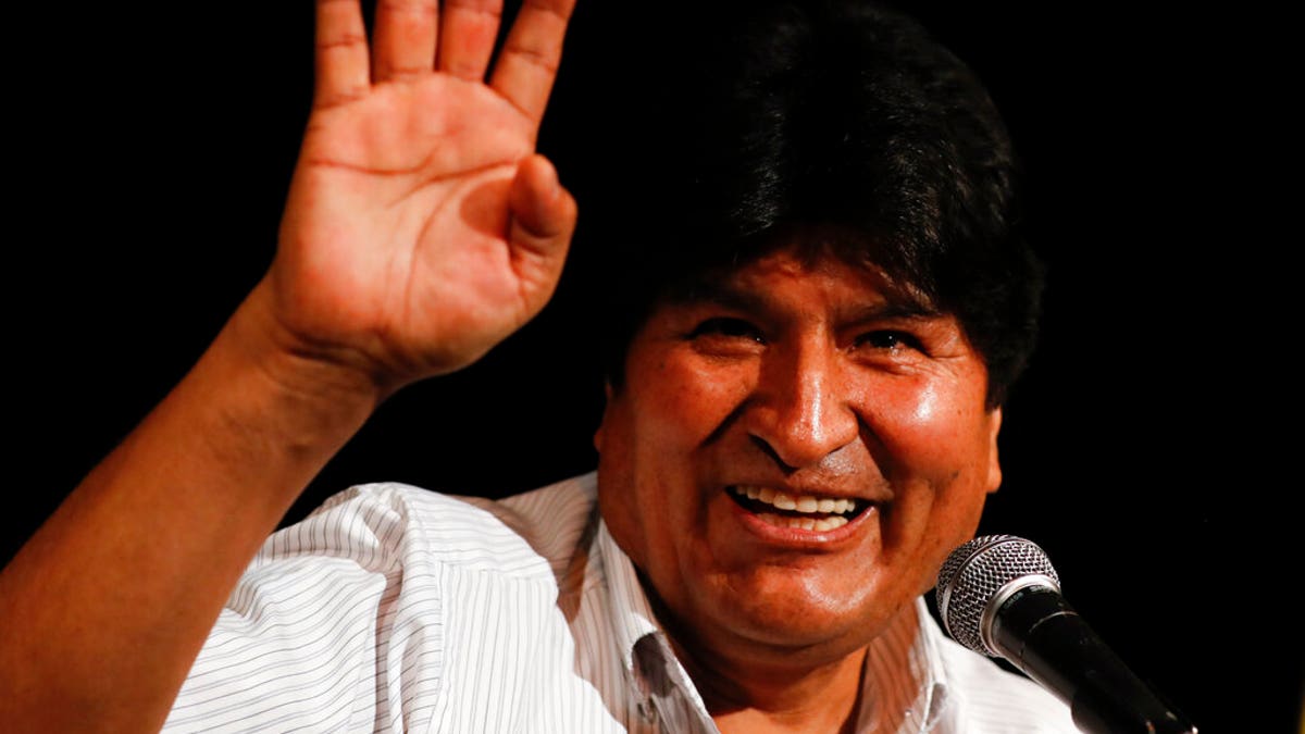 Bolivia's former President Evo Morales waves during a press conference in Buenos Aires.
