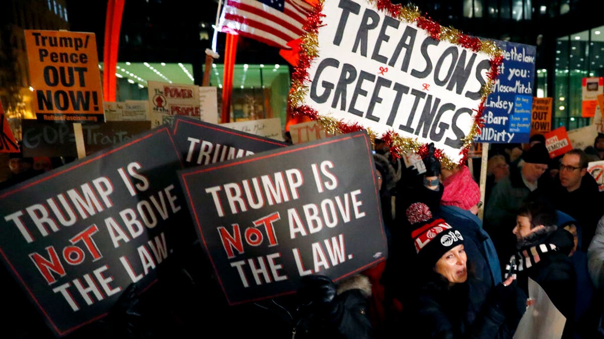 A crowd gathers on Federal Plaza for a protest against President Trump on the eve of a scheduled vote by the U.S. House of Representatives on the two articles of impeachment against the president, Tuesday, Dec. 17, 2019, in Chicago. (Associated Press)