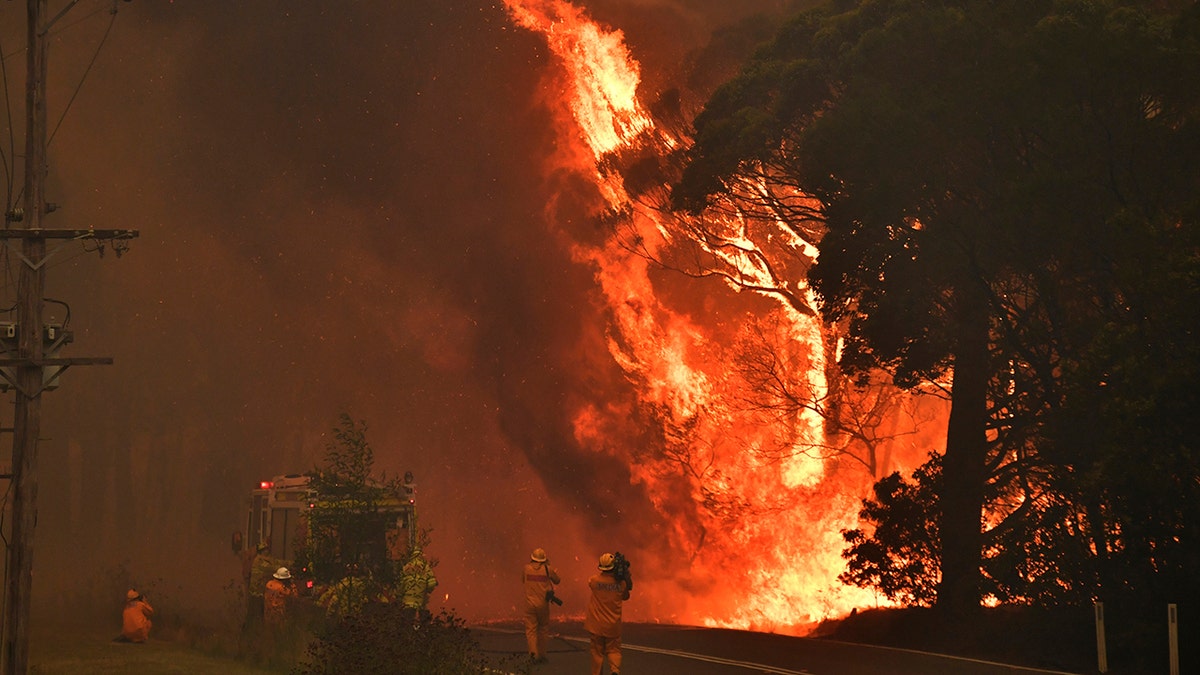 A fire truck is seen during a bushfire near Bilpin, 90 kilometers (56 miles) northwest of Sydney, Thursday, Dec. 19, 2019. Australia's most populous state of New South Wales declared a seven-day state of emergency Thursday as oppressive conditions fanned around 100 wildfires. (Mick Tsikas/AAP Images via AP)