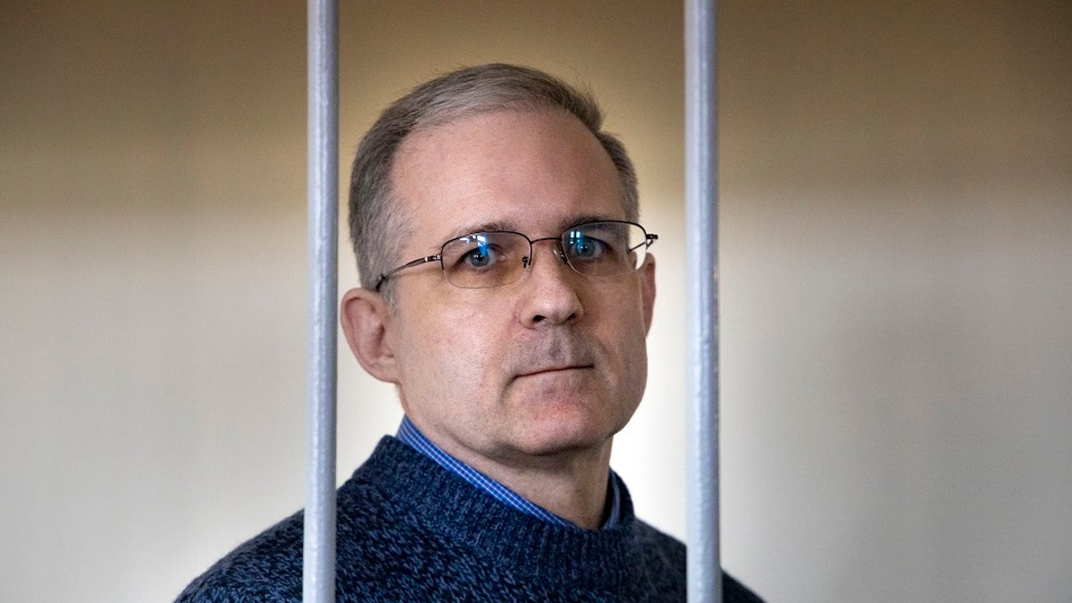 In this Aug. 23, 2019, file photo, Paul Whelan, a former U.S. marine who was arrested for alleged spying in Moscow on Dec. 28, 2018, speaks while standing in a cage as he waits for a hearing in a courtroom in Moscow, Russia. Whelan, who has been imprisoned in Russia on spying charges for nearly a year has lost his job with an automotive parts supplier in a corporate restructuring, a move his brother has denounced. (AP Photo/Alexander Zemlianichenko, File)