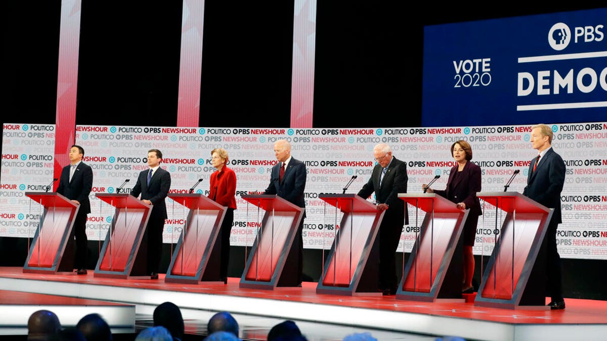 Democratic presidential candidates from left, entrepreneur Andrew Yang, South Bend Mayor Pete Buttigieg, Sen. Elizabeth Warren, D-Mass., former Vice President Joe Biden, Sen. Bernie Sanders, I-Vt., Sen. Amy Klobuchar, D-Minn., and businessman Tom Steyer stand on stage during a Democratic presidential primary debate Thursday, Dec. 19, 2019, in Los Angeles. (Associated Press)