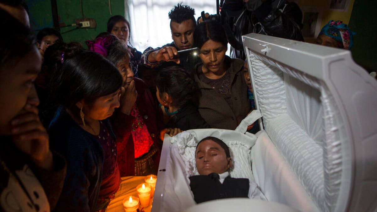 Family members pay their final respects to Felipe Gomez Alonzo in Yalambojoch, Guatemala, on Jan. 26. (AP Photo/Oliver de Ros, File)