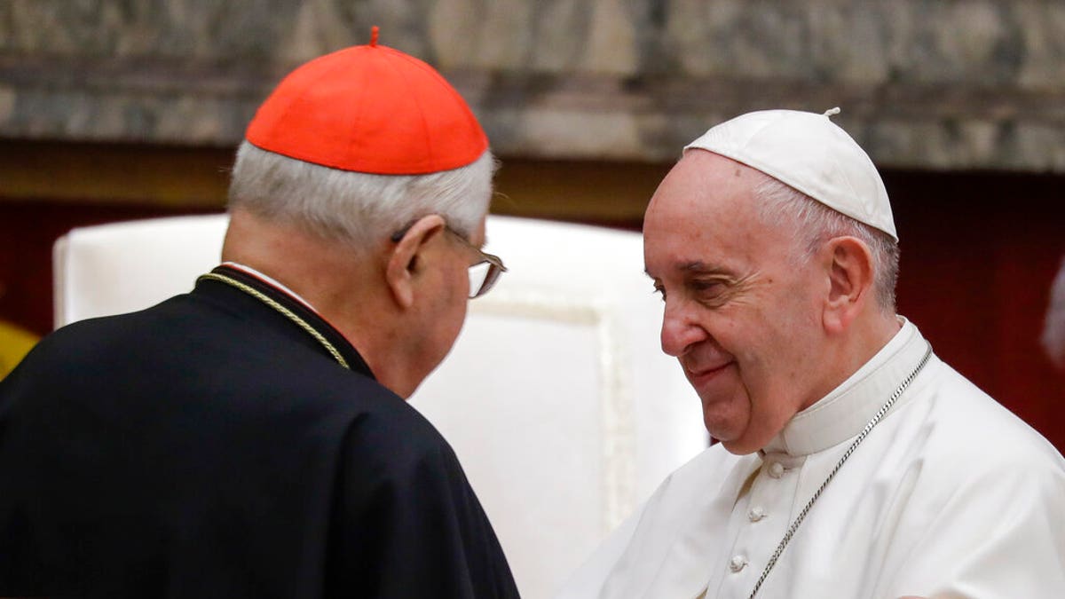 Pope Francis exchanges greetings with Cardinal Angelo Sodano, left, on the occasion of the pontiff's Christmas greetings to the Roman Curia, in the Clementine Hall at the Vatican.