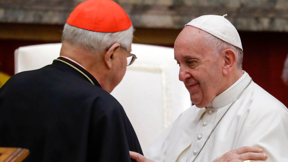 Pope Francis exchanges greetings with Cardinal Angelo Sodano, left, on the occasion of the pontiff's Christmas greetings to the Roman Curia, in the Clementine Hall at the Vatican.