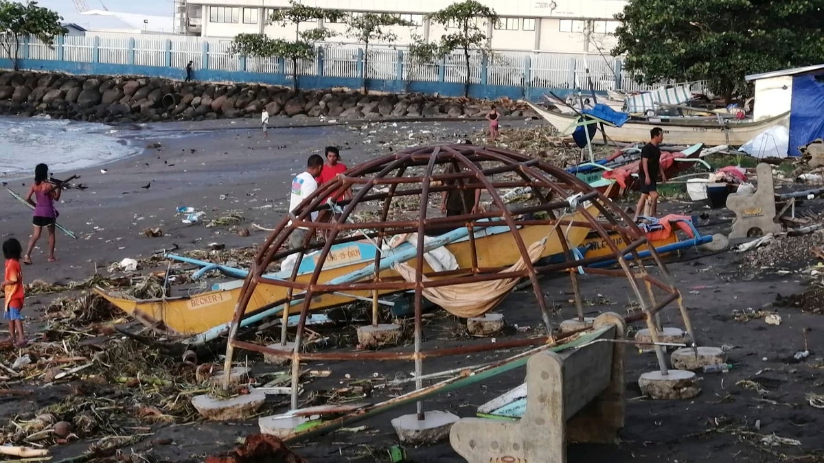An outrigger and playground equipment damaged by Typhoon Phanfone along the coastline in Ormoc city, central Philippines.