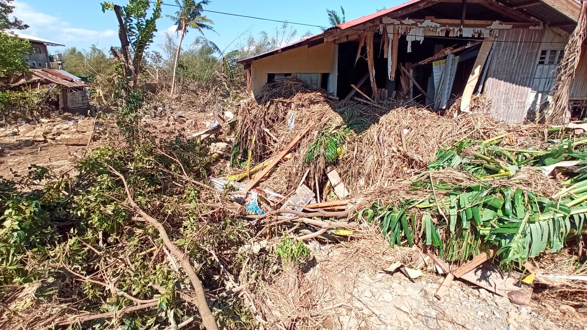 Debris from floods caused by Typhoon Phanfone surrounding a damaged house in Balasan Town, Iloilo province, central Philippines on Thursday.