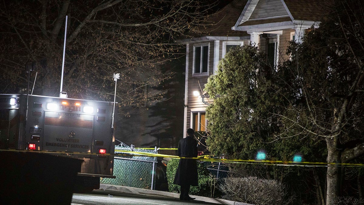 An Orthodox Jewish man stands in front of a residence in Monsey, N.Y., Sunday, Dec. 29, 2019, following a stabbing late Saturday during a Hanukkah celebration. A man attacked the celebration at the rabbi's home north of New York City late Saturday, stabbing and wounding several people before fleeing in a vehicle, police said. (Associated Press)