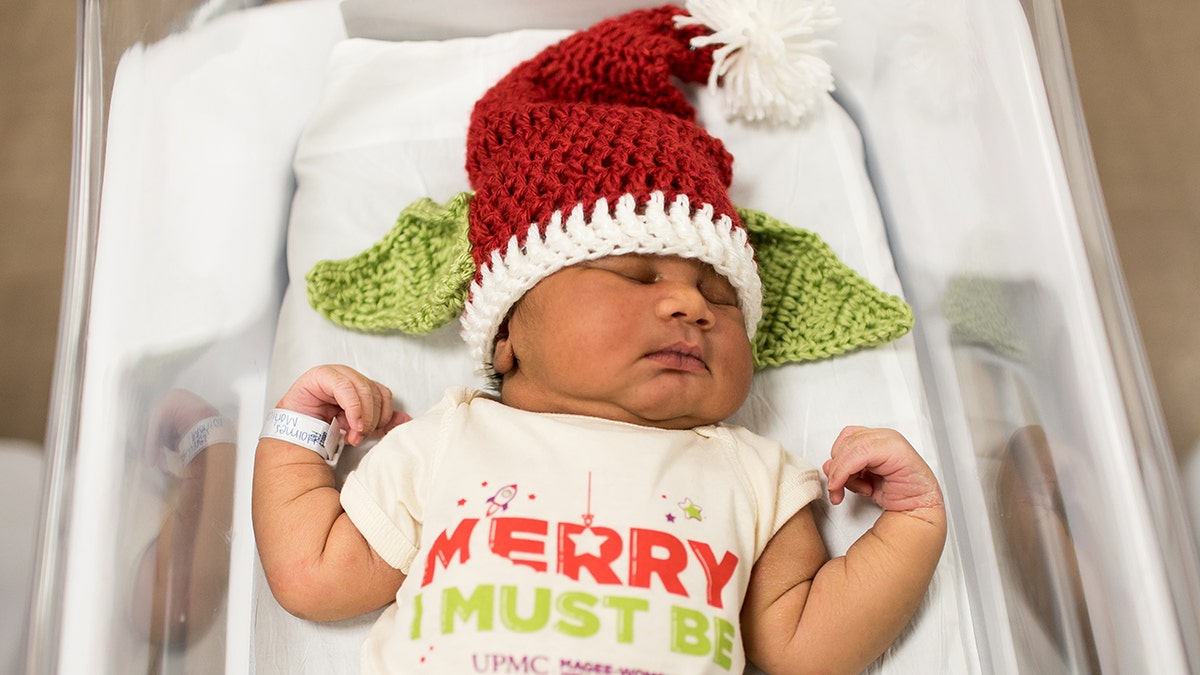 Dressing newborns in festive attire is part of a hospital tradition.