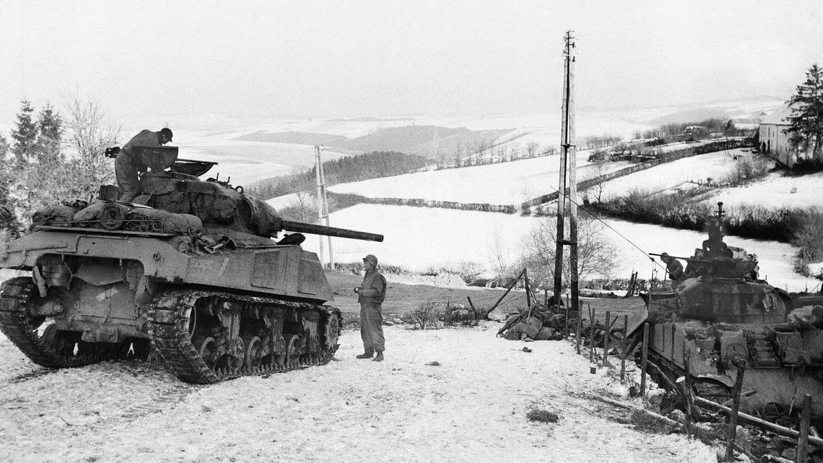 In this Jan. 6, 1945 file photo, American tanks wait on the snowy slopes in Bastogne, Belgium during the Battle of the Bulge.