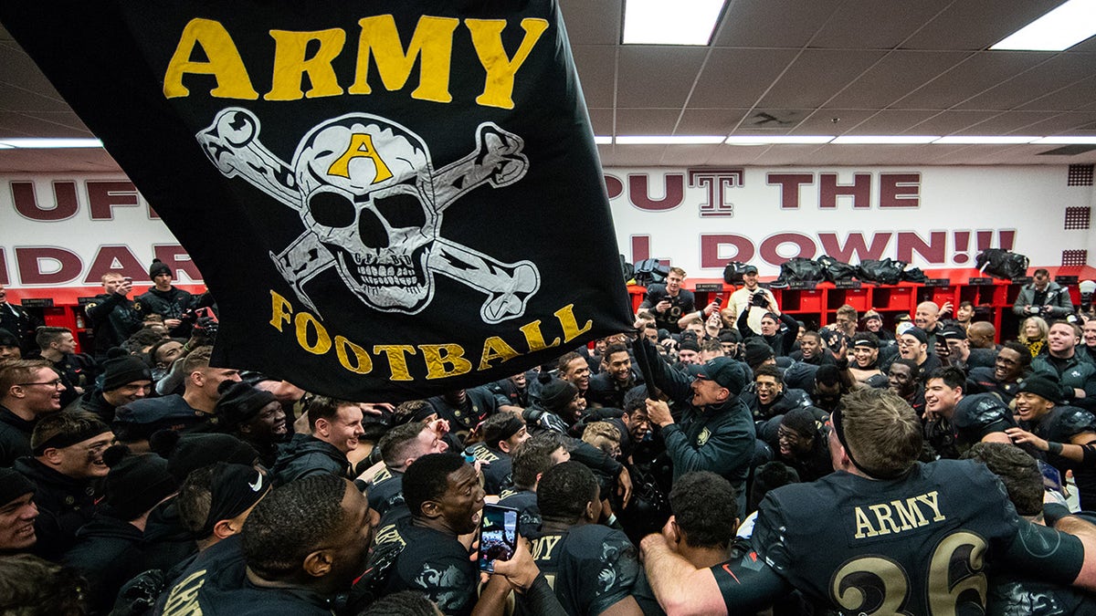 Jeff Monken, Head Coach of the Army Black Knights waves a flag in the locker room after defeating the Navy Midshipmen at Lincoln Financial Field on December 8, 2018 in Philadelphia, Pennsylvania. (Photo by Dustin Satloff/Getty Images)