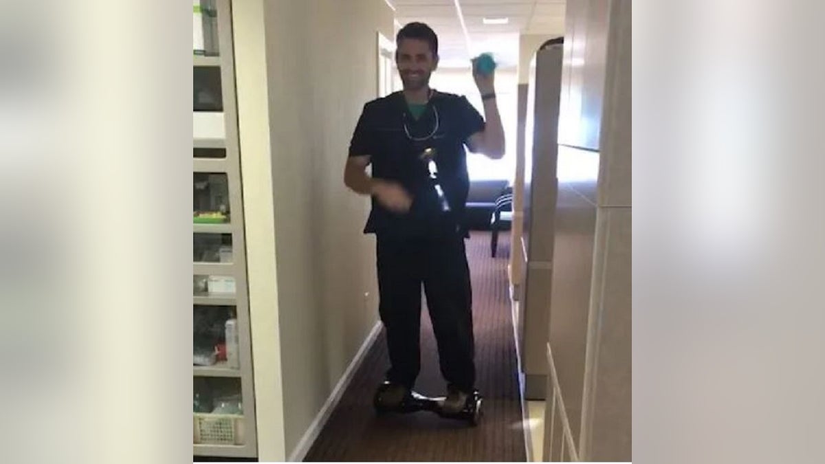 Alaska dentist Seth Lookhart in a video riding a hoverboard.