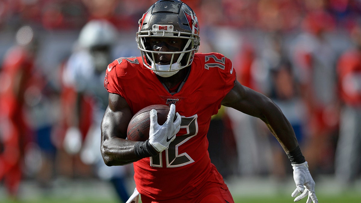 Tampa Bay Buccaneers wide receiver Chris Godwin (12) runs with the football after a reception against the Indianapolis Colts during the first half of an NFL football game Sunday, Dec. 8, 2019, in Tampa, Fla. (AP Photo/Jason Behnken)