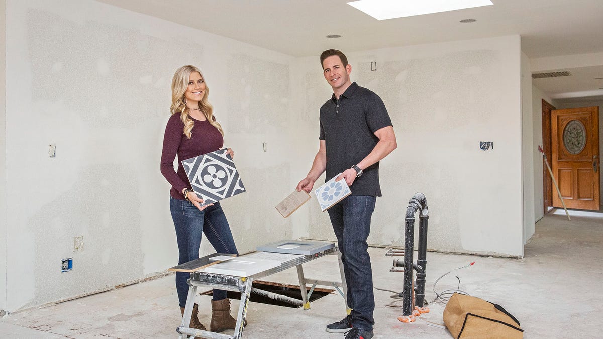 As seen on 'Flip or Flop,' real estate partners, Christina Anstead and Tarek El Moussa, pose as they pick out tiles for the kitchen of this Yorba Linda, Calif. home which they are hoping to flip for a profit.
